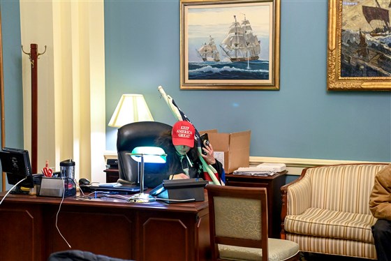 Photo: Protester sits at Capitol desk